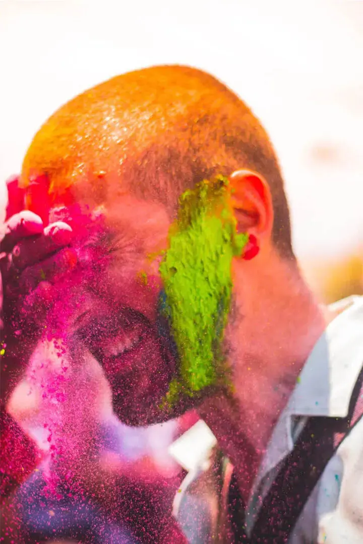 The close-up shot of a man playing with colors